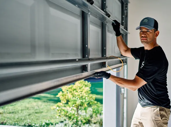 Technician inspecting a garage door
